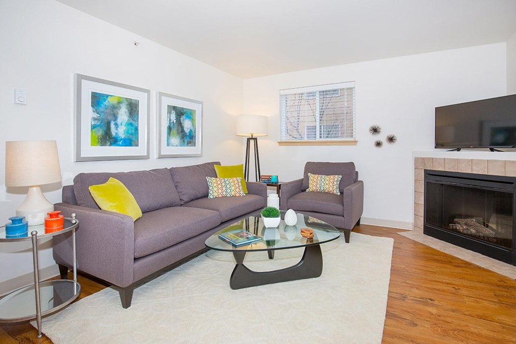 a living room with a couch and a coffee table and a fireplace